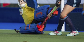 Someone playing field hockey